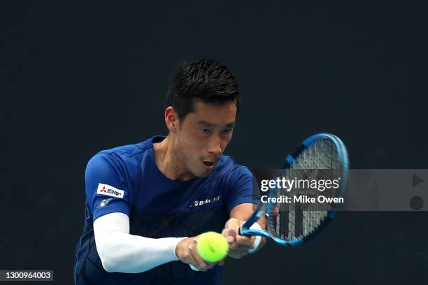 Yuichi Sugita of Japan plays a backhand in his Men's Singles first round match against Bernard Tomic of Australia during day one of the 2021...