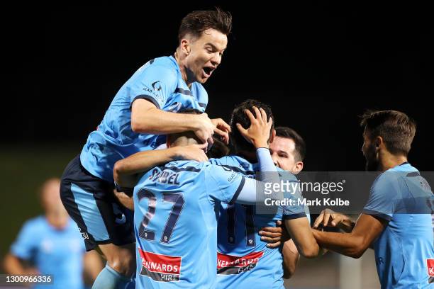 Alex Baumjohann of Sydney FC jumps on the pack as they celebrate with Kosta Barbarouses of Sydney FC after he scored a goal during the A-League match...