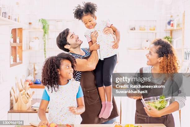 happy family cooking and cutting vegetables on kitchen. - chopping vegetables stock pictures, royalty-free photos & images