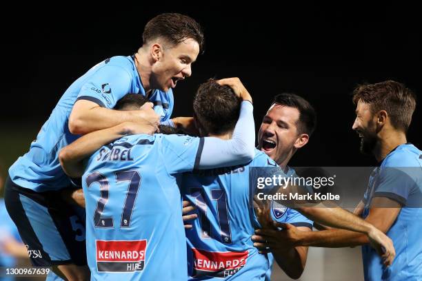 Alex Baumjohann of Sydney FC jumps on the pack as they celebrate with Kosta Barbarouses of Sydney FC after he scored a goal during the A-League match...