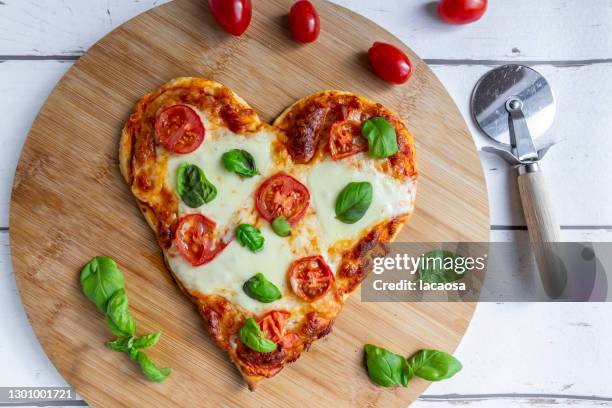 heart shaped pizza - heart shape pizza stock pictures, royalty-free photos & images