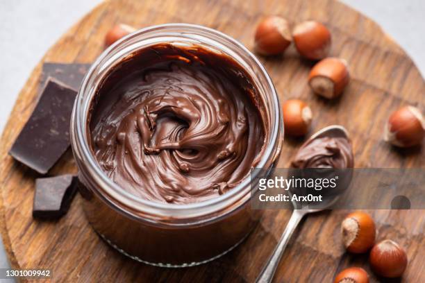 hazelnut chocolate spread in a jar - spread stock-fotos und bilder