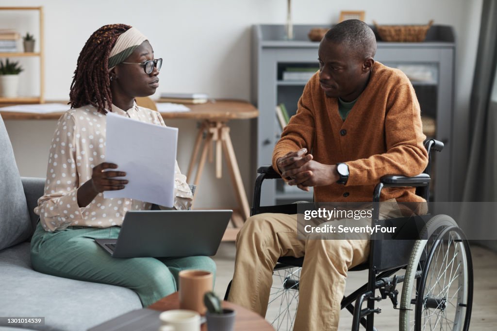 African-American Wheelchair User Talking to Business Consultant