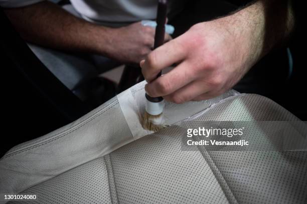 man cleaning leather car seat - cleaning inside of car stock pictures, royalty-free photos & images