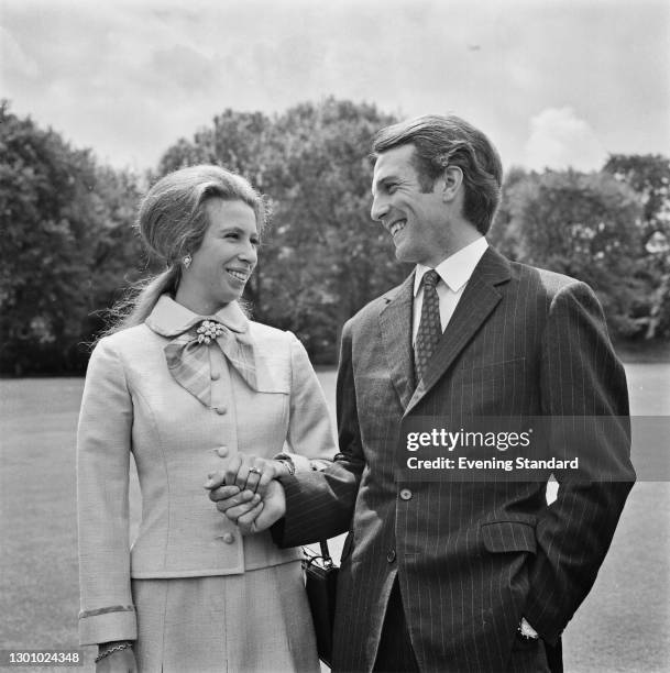 Anne, the Princess Royal, with her fiancé, equestrian champion Mark Phillips in the grounds of Buckingham Palace in London, following the...