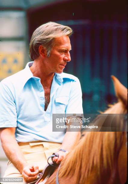 View of Canadian actor Christopher Plummer rides a horse during the filming of 'Eyewitness' , New York, New York, June 1980.
