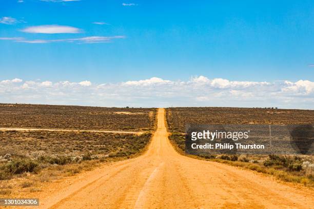 straight orange dirt road in outback australia - horizon over land stock pictures, royalty-free photos & images