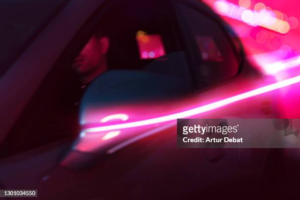 driving futuristic car with red light trail illuminated in the dark night. - barcelona free stockfoto's en -beelden