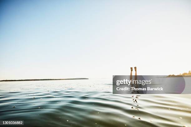 mans feet in air while diving under water - upside-down stock pictures, royalty-free photos & images