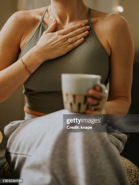 woman with hand on chest heart for breathing calming exercise feeling gratitute - woman gratitude stock pictures, royalty-free photos & images