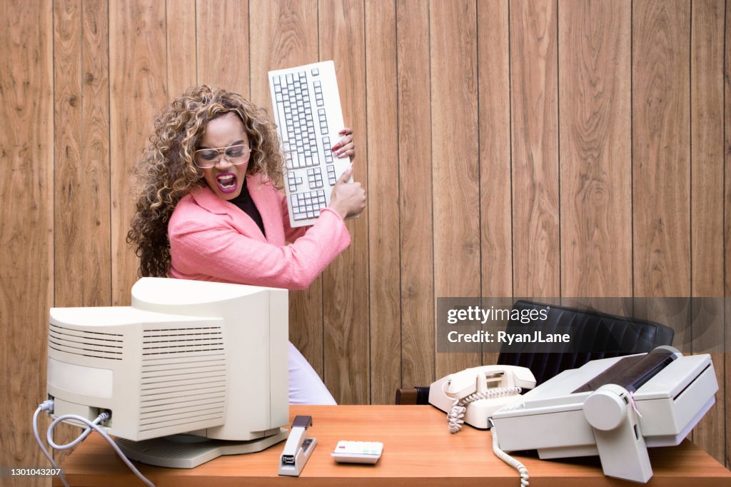 Angry Retro Secretary At Computer Desk In Office