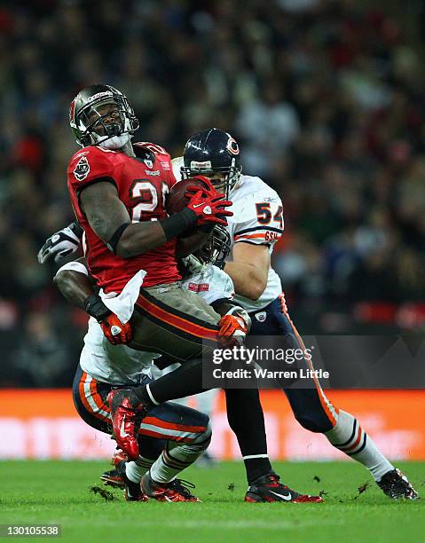 Kregg Lumpkin of the Tampa Bay Buccaneers is brought down by Charles Tillman of the Chicago Bears during the NFL International Series match between...