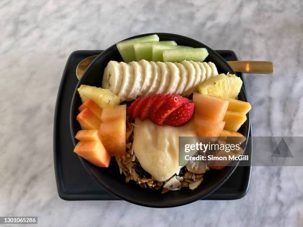 bowl of granola with sliced fruit and lemon curd - metal serving tray stock pictures, royalty-free photos & images