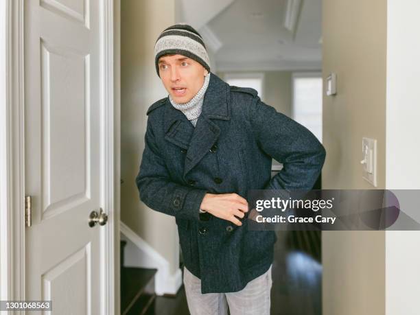 man reaches into coat pocket - jacket pocket stock pictures, royalty-free photos & images