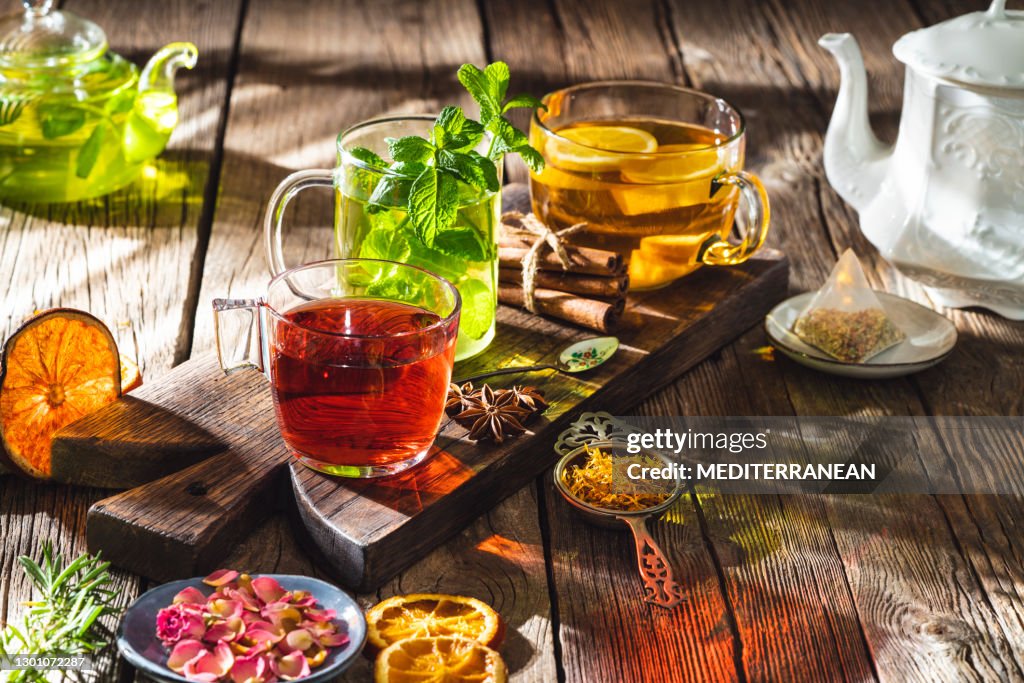 Tea and herbal infusion with dried herbs on wooden rustic table board