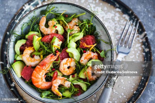 delicious fresh salad with prawns, grapefruit, avocado, cucumber and herbs - avocado salad stock pictures, royalty-free photos & images