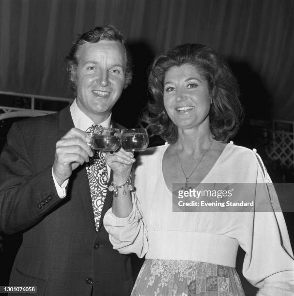 English actor and television presenter Nicholas Parsons with his wife, actress Denise Bryer, UK, June 1973.