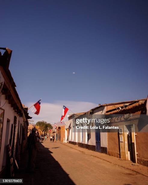 street in san pedro de atacama with chilean flags on it, chile - san pedro stock pictures, royalty-free photos & images