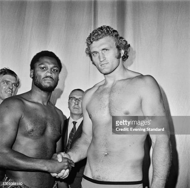 British boxer Joe Bugner shakes hands with US boxer Joe Frazier at the weigh-in before their fight at Earl's Court in London, UK, 19th June 1973.