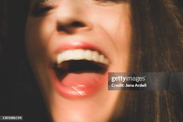 closeup woman laughing mouth, shouting mouth - mund stock-fotos und bilder