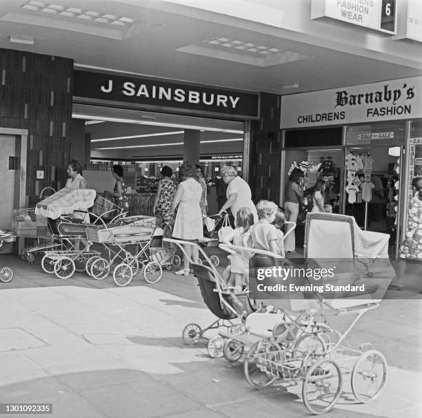 Empty prams outside the J Sainsbury store in Ilford, east London, UK, 14th August 1973. Next door is a Barnaby's children's fashion boutique.