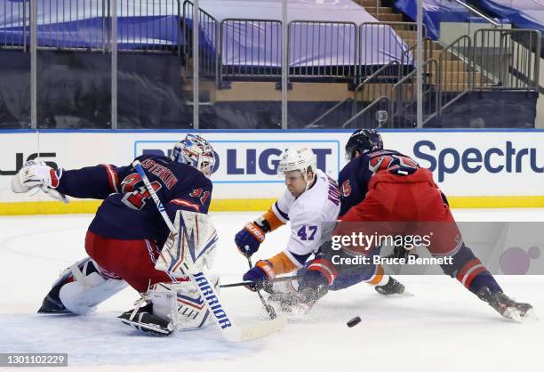 Igor Shesterkin and Libor Hajek of the New York Rangers combine to stop Leo Komarov of the New York Islanders during the first period at Madison...