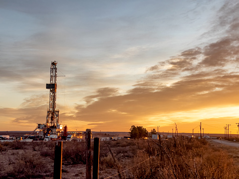 Oil Or Gas Drill Fracking Rig Pad As The Sun Sets In The Background, New Mexico