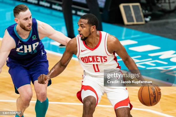 Sterling Brown of the Houston Rockets brings the ball up court while guarded by Gordon Hayward of the Charlotte Hornets during the second quarter at...