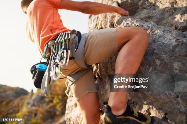 close-up of an unrecognizable man with carabiner and safety harness - clambering imagens e fotografias de stock