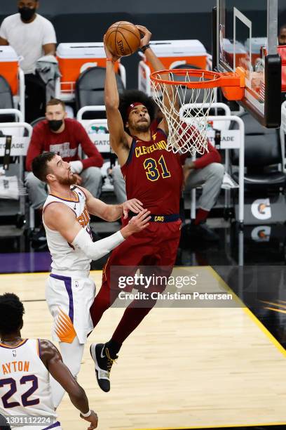 Jarrett Allen of the Cleveland Cavaliers slam dunks the ball past Frank Kaminsky of the Phoenix Suns during the first half of the NBA game at Phoenix...