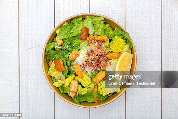 fresh salad in paper bowl - caesar salad stock pictures, royalty-free photos & images