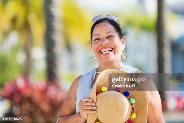 senior hispanic woman by swimming pool - wide brim stock pictures, royalty-free photos & images