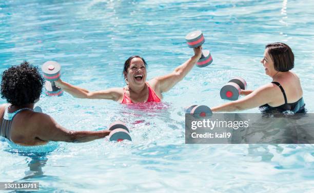 three senior women doing water aerobics - water aerobics stock pictures, royalty-free photos & images