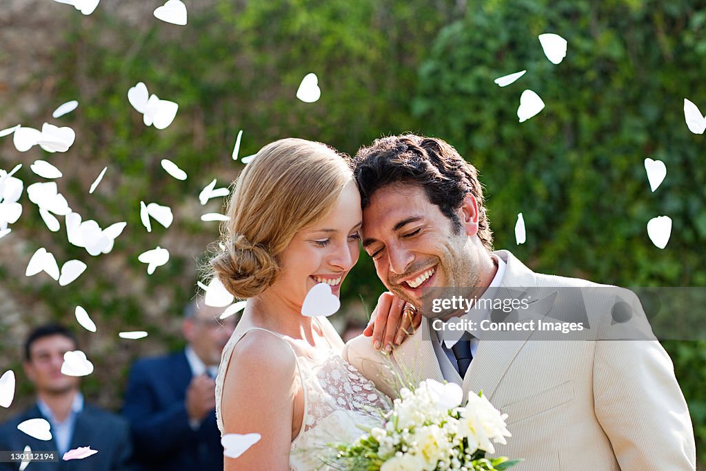 Newlyweds embracing at marriage ceremony