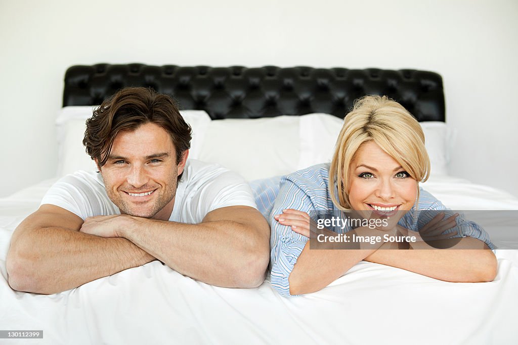 Couple lying on bed, portrait