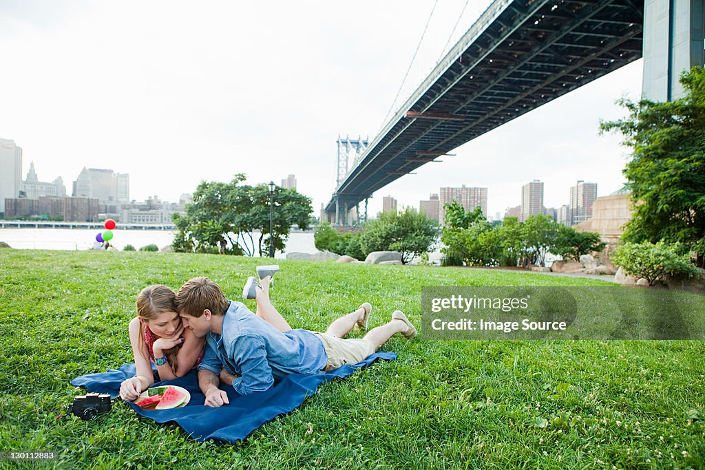 Young couple having picnic in a park