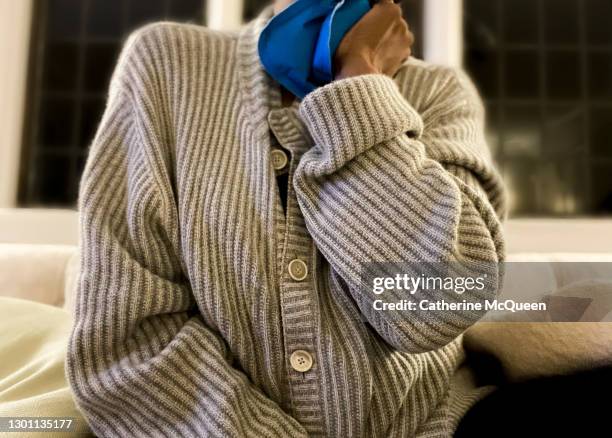 african-american woman holding heating pad to neck - heat pad stock pictures, royalty-free photos & images