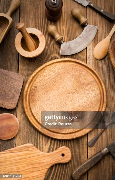 round wooden cutting board and kitchen utensils - wooden tray stock pictures, royalty-free photos & images