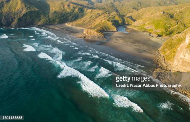 drone view of a beach with small hills. - new zealand beach stock pictures, royalty-free photos & images