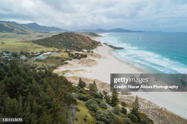 scene of a beautiful coastline in cloud cover. - northland region stock pictures, royalty-free photos & images