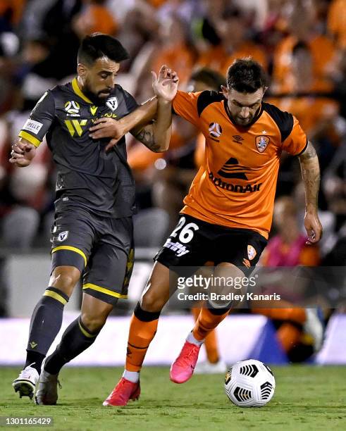 James O'Shea of the Roar takes on the defence of Benat Etxebarria of Macarthur during the A-League match between the Brisbane Roar and Macarthur FC...