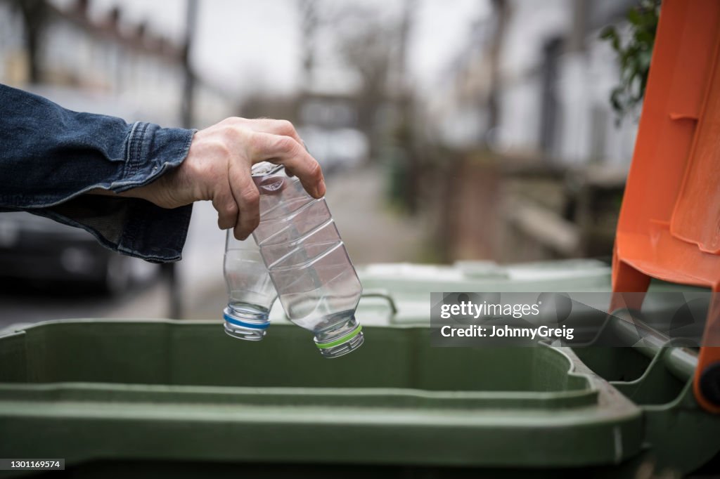 Socially responsible Caucasian man recycling plastic bottles