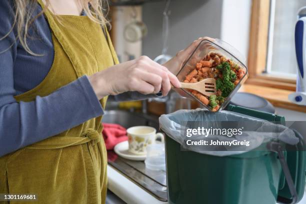 kaukasische vrouw die plantaardige resten toevoegt aan compostbak - daily bucket stockfoto's en -beelden