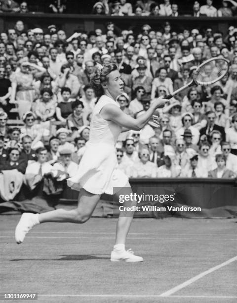 Maureen Connolly of the United States makes a running forehand return to Joan Scott of South Africa during their Women's Singles Second Round match...