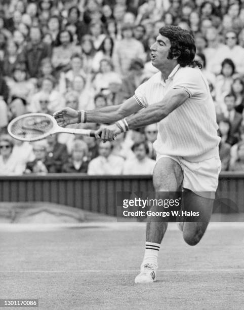 Manuel Orantes of Spain makes a forehand return against Georges Goven of France during their Men's Singles First Round match of the Wimbledon Lawn...