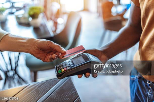 close-up on a contactless payment at a cafe - nfc payment stock pictures, royalty-free photos & images