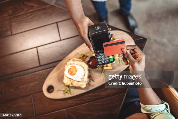 sluit eenvoudige betaling met creditcard binnenshuis - card reader stockfoto's en -beelden