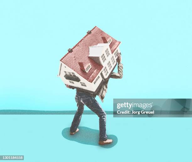 man carrying a house - over burdened stock pictures, royalty-free photos & images