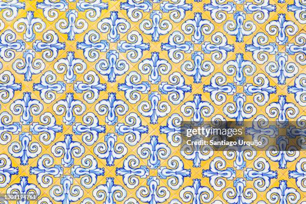 yellow and blue tiles on a wall - blue tiles stock pictures, royalty-free photos & images