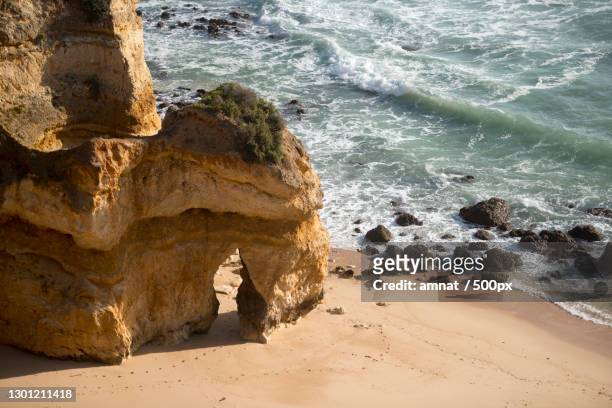 high angle view of rocks on beach - ponta da piedade stock pictures, royalty-free photos & images